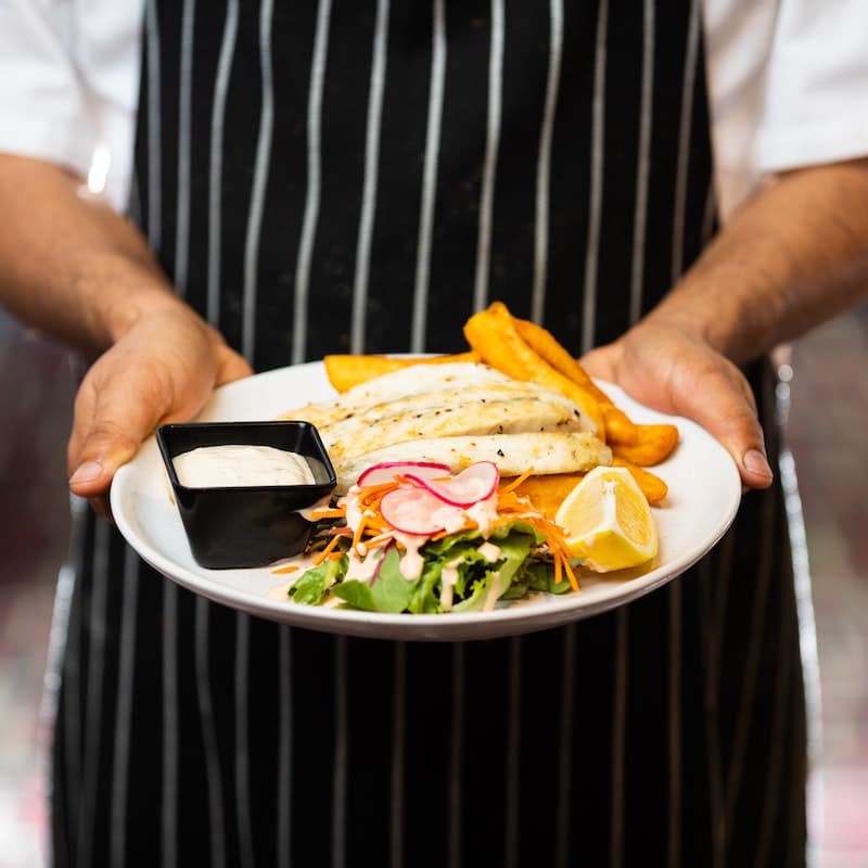 A chef presenting their dish